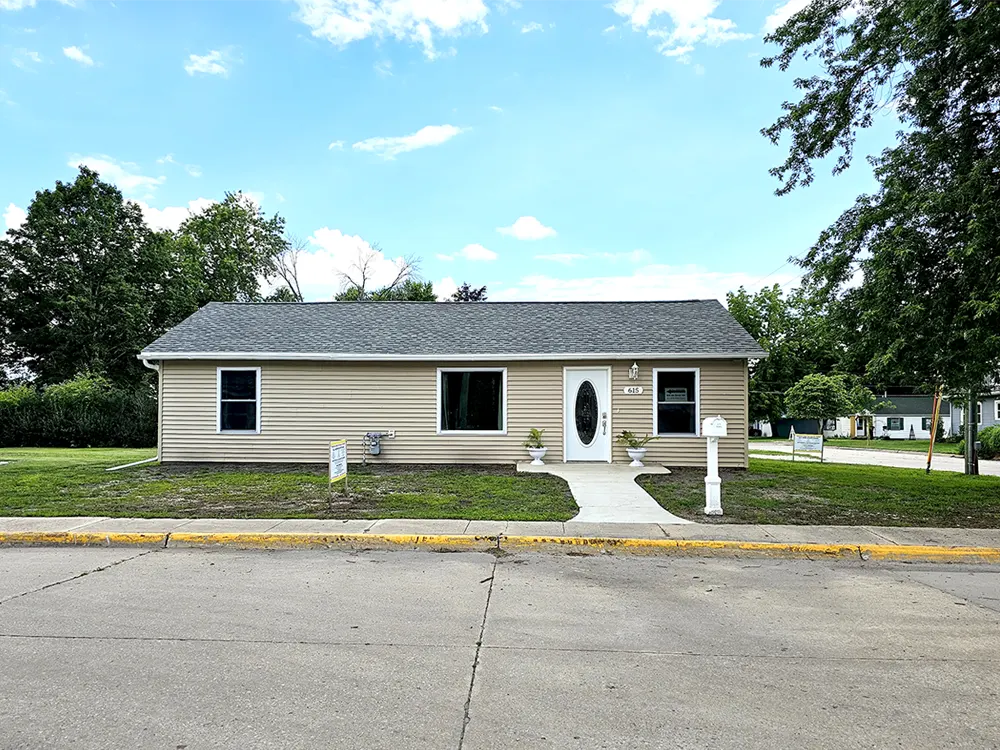 Front door and exterior view of the house on the North side of property