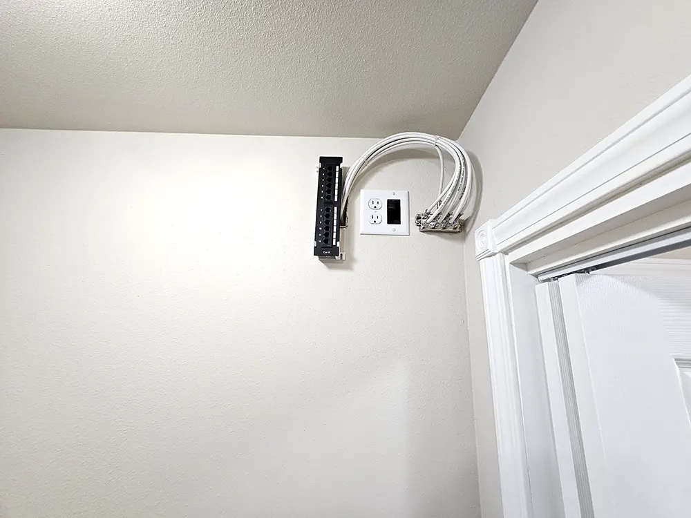 This is the centralized networking hub that provides organized whole-house distribution for internet, phone, and cable service, along with a roof-mounted wired TV antenna offering about 40 high-quality local channels.