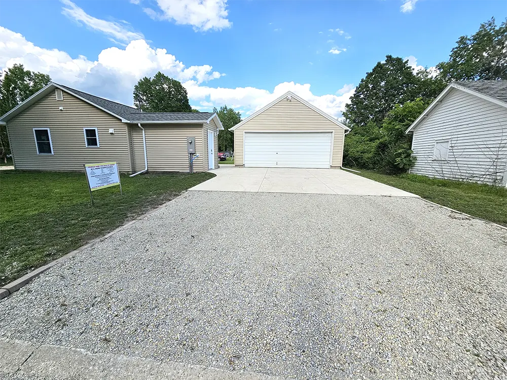 View of the driveway on the West side of the property that leads to the back door and the breezeway to the private patio.